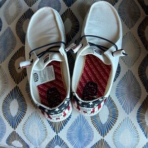 White HeyDudes with American Flag on heel.